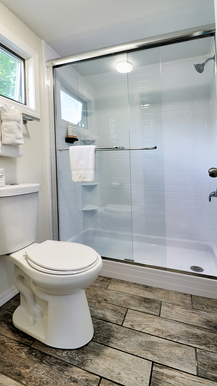 A bathroom with a toilet and shower
